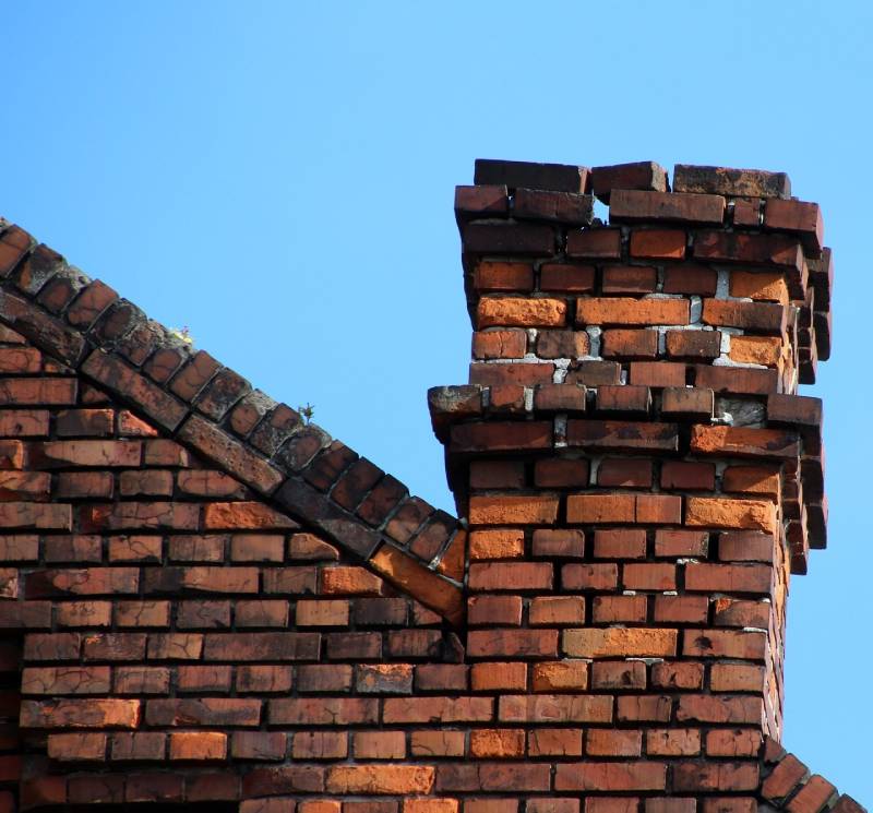 Signs Your Lake Arbor Home Needs a Chimney Inspection Damaged chimney on an Lake Arbor home showing cracks and missing mortar